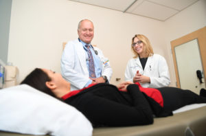 Dr's Linehan and Twardowski talking to a patient