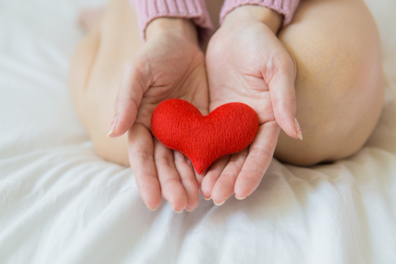 women holding a stuffed heart in her hands