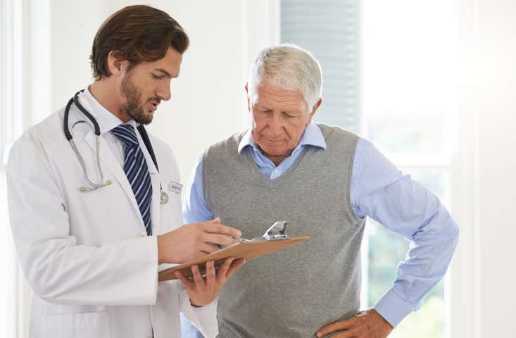 Older male patient talking to a doctor