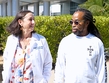 Dr. Tracey Childs walks with Elridge Cavitt at Saint John's Health Center