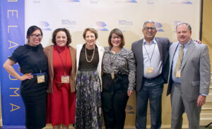 Doctors pose at the step-and-repeat-banner-at-the-santa-monica-melanoma-symposium