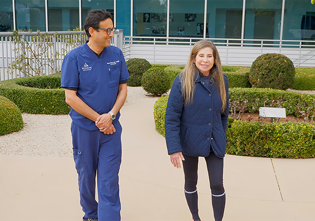 Dr. Deven Khosla walks with Stacy in the rose garden