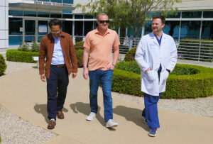 Tanner walkls with Dr. Kristedja and Dr. Fischer