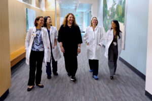 Valerie walks with her doctors at Saint John's Health Center.