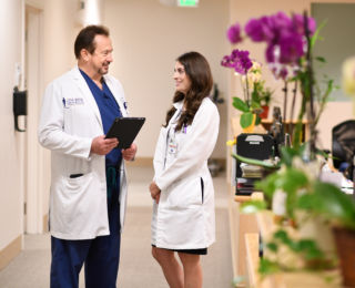 Two doctors speaking in the hallway of JWCI