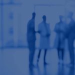 Doctors standing in hallway of hospital with a blue hue to picture