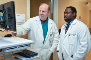 Dr. McKenna and Dr. Onugha discussing a chest wall tumor diagnosis
