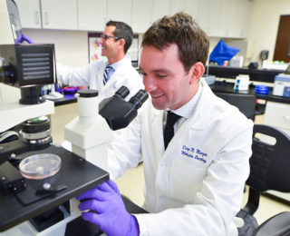 Two research scientists observing specimens