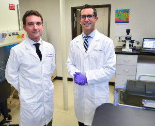 Two Research scientists standing in the Cancer Epigenetics Lab at JWCI