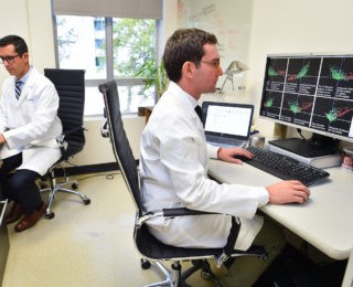 Doctors looking over documents at the Cancer Epigenetics Research Lab