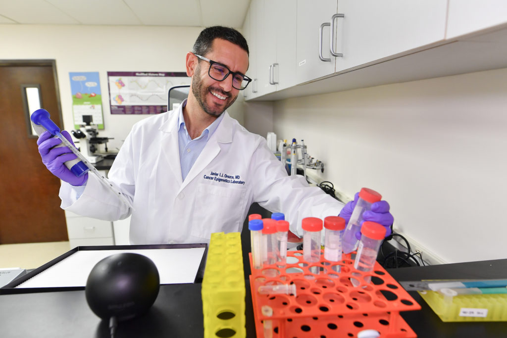 Research Scientist smiling looking at samples