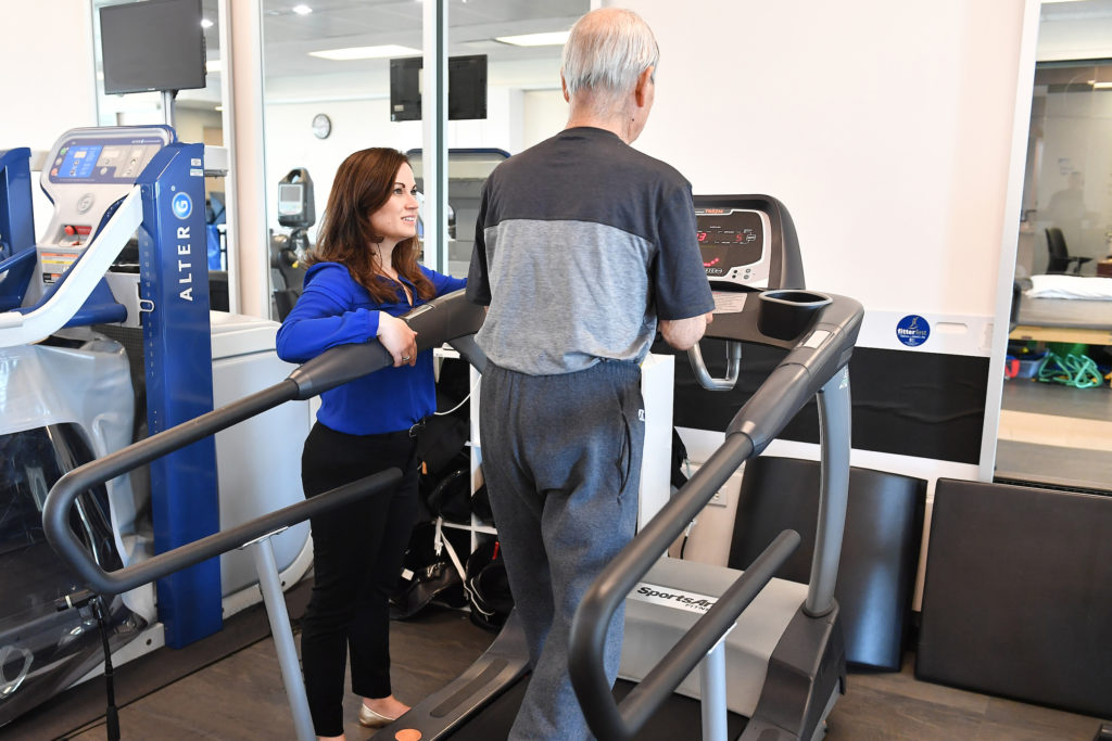 patient working though physical therapy with doctor