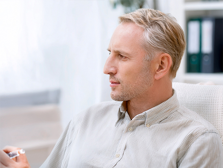 male patient with oropharyngeal cancer talking to doctor.