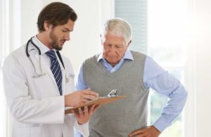 Older male patient talking to a doctor